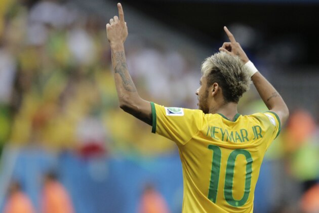 Brazil's Neymar celebrates after scoring his side's second goal during the group A World Cup soccer match between Cameroon and Brazil at the Estadio Nacional in Brasilia, Brazil, Monday, June 23, 2014. (AP Photo/Bernat Armangue)