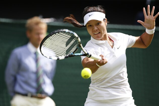 Li Na of China plays a return to Paula Kania of Poland during their first round match at the All England Lawn Tennis Championships in Wimbledon, London,  Monday, June  23, 2014. (AP Photo/Pavel Golovkin)