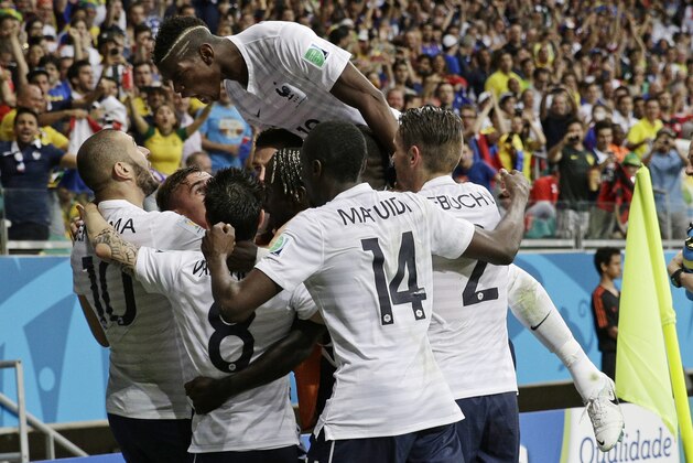 French players celebrate after France's Karim Benzema, left,  scored his side's fourth goal during the group E World Cup soccer match between Switzerland and France at the Arena Fonte Nova in Salvador, Brazil, Friday, June 20, 2014.    (AP Photo/Christophe Ena)