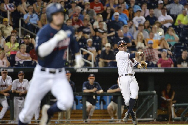 Virginia third baseman Kenny Towns (9) handles a ground ball as Vanderbilt right fielder Rhett Wiseman runs safely to first base in the seventh inning of game one of the best-of-three NCAA baseball College World Series finals in Omaha, Neb., Monday, June 23, 2014. (AP Photo/Ted Kirk)