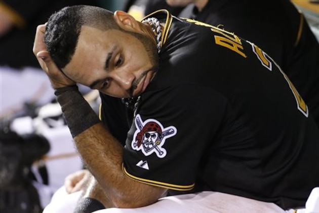 Pittsburgh Pirates' Pedro Alvarez sits in the dugout after scoring on a single by Pirates' Gregory Polanco during the fifth inning of a baseball game against the Cincinnati Reds in Pittsburgh Wednesday, June 18, 2014. (AP Photo/Gene J. Puskar)