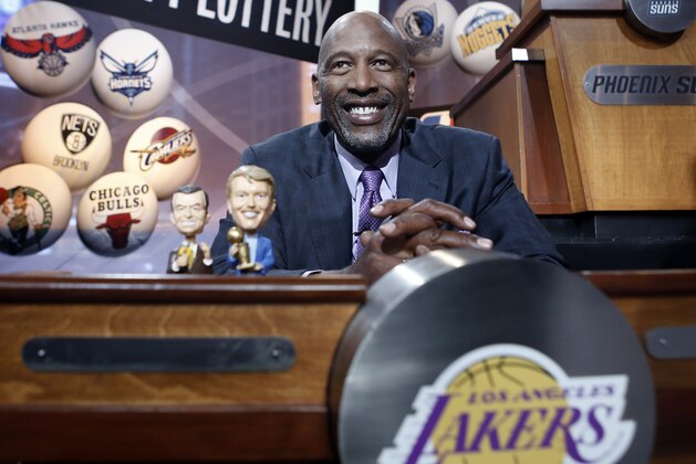 Basketball Hall of Famer James Worthy smiles before the start of the NBA basketbal draft lottery in New York, Tuesday, May 20, 2014. Worthy brought bobble-head dolls of the late Lakers broadcaster Chick Hearn and the late Lakers owner Jerry Buss with him for good luck. (AP Photo/Kathy Willens)