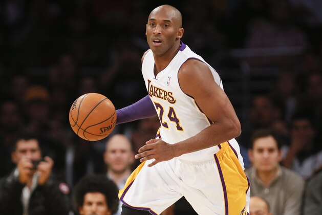 Los Angeles Lakers' Kobe Bryant dribbles the ball against the Toronto Raptors during the first half of an NBA basketball game in Los Angeles, Sunday, Dec. 8, 2013. It was Bryant's first game back after a torn left Achilles tendon injury on April 12th and the Raptors won 106-94. (AP Photo/Danny Moloshok)