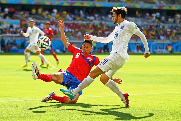 BELO HORIZONTE, BRAZIL - JUNE 24: Adam Lallana of England is challenged by Oscar Duarte of Costa Rica during the 2014 FIFA World Cup Brazil Group D match between Costa Rica and England at Estadio Mineirao on June 24, 2014 in Belo Horizonte, Brazil.  (Photo by Richard Heathcote/Getty Images)