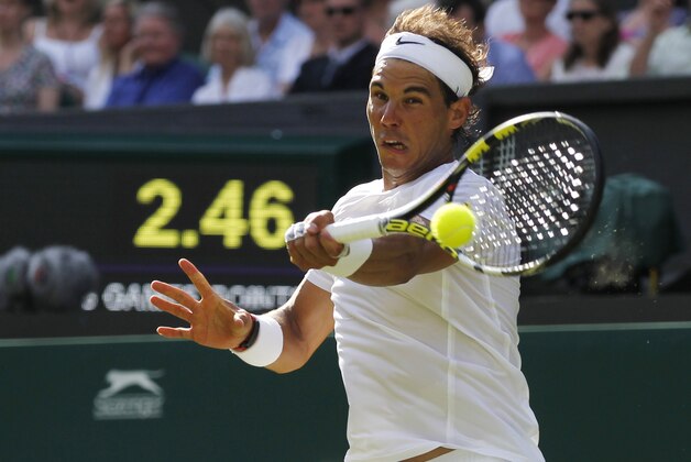 Rafael Nadal of Spain plays a return to Martin Klizan of Slovakia during their match at the All England Lawn Tennis Championships in Wimbledon, London, Tuesday, June 24, 2014. (AP Photo/Sang Tan)