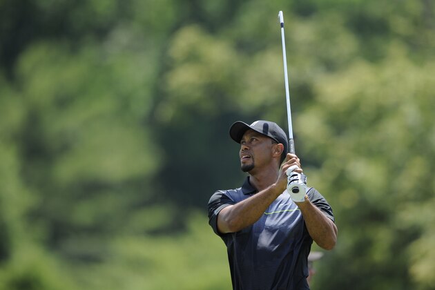 Tiger Woods watches his drive from the driving range as he practices at the Quicken Loans National golf tournament, Tuesday, June 24, 2014, in Bethesda, Md. (AP Photo/Nick Wass)
