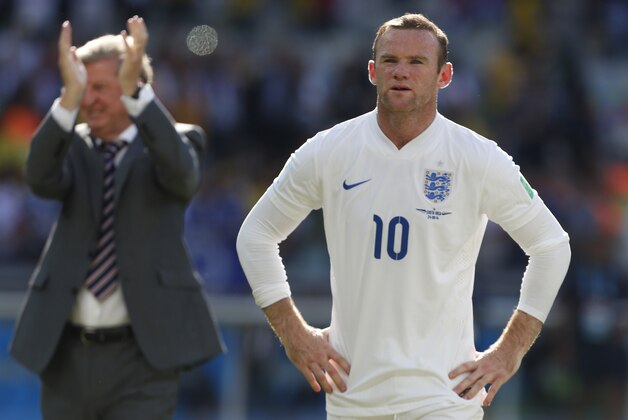 England's Wayne Rooney stands in front of England fans after the group D World Cup soccer match between Costa Rica and England at the Mineirao Stadium in Belo Horizonte, Brazil, Tuesday, June 24, 2014.  The match ended in a 0-0 draw. (AP Photo/Jon Super)