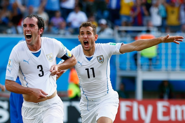 NATAL, BRAZIL - JUNE 24:  Diego Godin of Uruguay (L) celebrates scoring his team's first goal during the 2014 FIFA World Cup Brazil Group D match between Italy and Uruguay at Estadio das Dunas on June 24, 2014 in Natal, Brazil.  (Photo by Clive Rose/Getty Images)
