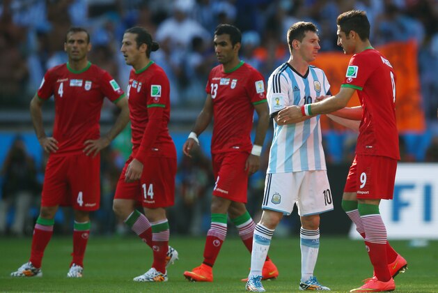 BELO HORIZONTE, BRAZIL - JUNE 21: Lionel Messi of Argentina shakes hands with Alireza Jahan Bakhsh of Iran after a 1-0 win by Argentina during the 2014 FIFA World Cup Brazil Group F match between Argentina and Iran at Estadio Mineirao on June 21, 2014 in Belo Horizonte, Brazil.  (Photo by Jeff Gross/Getty Images)
