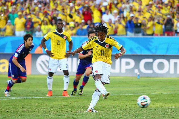 CUIABA, BRAZIL - JUNE 24:  Juan Guillermo Cuadrado of Colombia shoots and scores his team's first goal on a penalty kick during the 2014 FIFA World Cup Brazil Group C match between Japan and Colombia at Arena Pantanal on June 24, 2014 in Cuiaba, Brazil.  (Photo by Mark Kolbe/Getty Images)