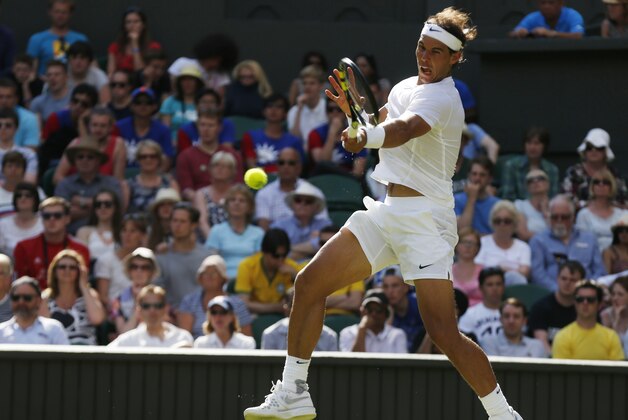 Rafael Nadal of Spain plays a return to Martin Klizan of Slovakia during their match at the All England Lawn Tennis Championships in Wimbledon, London, Tuesday, June 24, 2014. (AP Photo/Sang Tan)