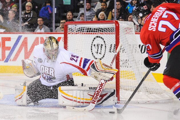CALGARY, AB - JANUARY 15: Mason McDonald #29 of Team Orr receives a snow shower as he eyes the shot of Nikita Scherbak #27 of Team Cherry during the CHL Top Prospects game at Scotiabank Saddledome on January 15, 2014 in Calgary, Alberta, Canada. (Photo by Derek Leung/Getty Images)