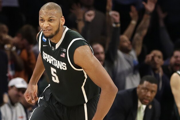 Michigan State's Adreian Payne celebrates after scoring in the second half of a regional semifinal against Virginia at the NCAA men's college basketball tournament, early Saturday, March 29, 2014, in New York. Michigan State won 61-59. (AP Photo/Seth Wenig)