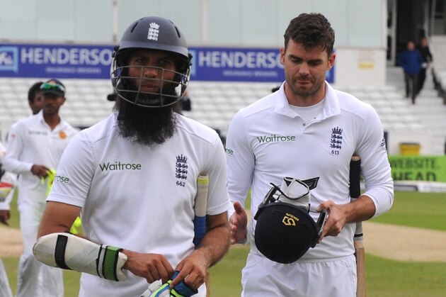 England's Moeen Ali, left, and James Anderson leave the field after Sri Lanka beat England by 100 runs to win the series during day five of the Second Test Match between England and Sri Lanka at Headingley cricket ground, Leeds, England, on Tuesday, June 24, 2014. (AP Photo/Rui Vieira)