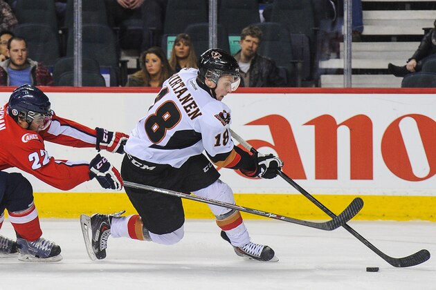 CALGARY, AB - MARCH 11: Jake Virtanen #18 of the Calgary Hitmen skates past Lenny Hackman #22 of the Lethbridge Hurricanes during a WHL game at Scotiabank Saddledome on March 11, 2014 in Calgary, Alberta, Canada. The Hitmen defeated the Hurricans 5-3. (Photo by Derek Leung/Getty Images)