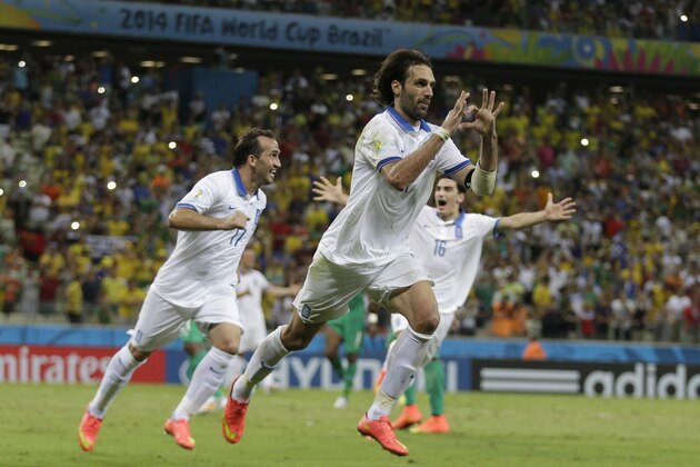 Greece's Giorgos Samaras celebrates scoring his side's 2nd goal from the penalty spot during the group C World Cup soccer match between Greece and Ivory Coast at the Arena Castelao in Fortaleza, Brazil, Tuesday, June 24, 2014. (AP Photo/Natacha Pisarenko)