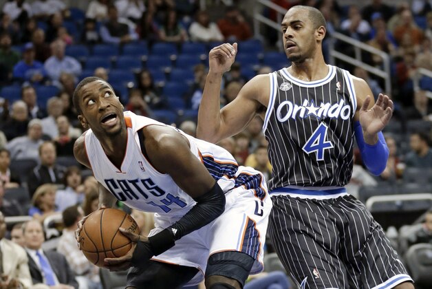 Charlotte Bobcats' Michael Kidd-Gilchrist, left, looks for an open shot as he is guarded by Orlando Magic's Arron Afflalo (4) in the first half of an NBA basketball game in Orlando, Fla., Friday, Jan. 17, 2014. (AP Photo/John Raoux)