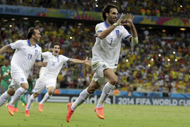 Greece's Giorgos Samaras celebrates scoring his side's 2nd goal from the penalty spot during the group C World Cup soccer match between Greece and Ivory Coast at the Arena Castelao in Fortaleza, Brazil, Tuesday, June 24, 2014. (AP Photo/Natacha Pisarenko)