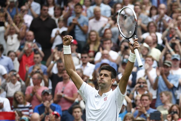 Novak Djokovic of Serbia celebrates after winning his first round match against Andrey Golubev of Kazakhstan at the All England Lawn Tennis Championships in Wimbledon, London, Monday, June  23, 2014. (AP Photo/Pavel Golovkin)