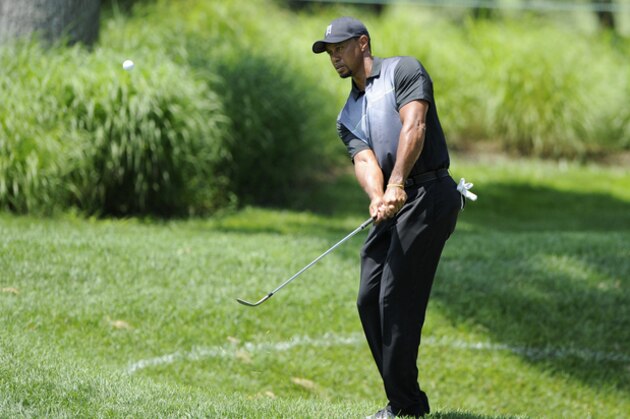 Tiger Woods chips as he practices at the Quicken Loans National golf tournament, Tuesday, June 24, 2014, in Bethesda, Md. (AP Photo/Nick Wass)