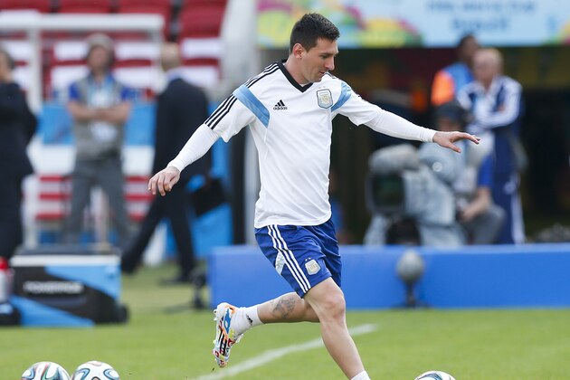 Argentina's Lionel Messi, right, kicks a ball  during a training session at the Beira-Rio Stadium in Porto Alegre, Brazil, Tuesday, June 24, 2014.  Argentina plays in group F of the 2014 soccer World Cup. (AP Photo/Victor R. Caivano)