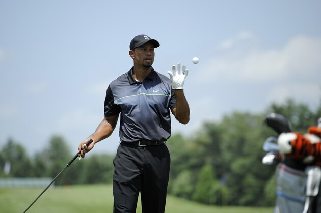 Tiger Woods catches a ball at the driving range as he practices at the Quicken Loans National golf tournament, Tuesday, June 24, 2014, in Bethesda, Md. (AP Photo/Nick Wass) Tiger Woods catches a ball at the driving range as he practices at the Quicken Loans National golf tournament, Tuesday, June 24, 2014, in Bethesda, Md. (AP Photo/Nick Wass)