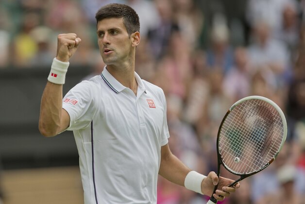 Jun 23, 2014; London, United Kingdom; Novak Djokovic (SRB) celebrates recording match point during his match against Andrey Golubev (KAZ) on day one of the 2014 Wimbledon Championships at the All England Lawn and Tennis Club. Mandatory Credit: Susan Mullane-USA TODAY Sports