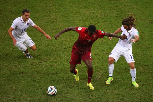 MANAUS, BRAZIL - JUNE 22:  William Carvalho of Portugal takes on Graham Zusi and Kyle Beckerman of the United States during the 2014 FIFA World Cup Brazil Group G match between the United States and Portugal at Arena Amazonia on June 22, 2014 in Manaus, Brazil.  (Photo by Elsa/Getty Images)