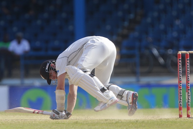 New Zealand batsman Kane Williamson fall on the ground a shot played during the second innings on the third day of their second cricket Test matchagainst West Indies in Port of Spain, Trinidad, Wednesday, June 18, 2014. (AP Photo/Arnulfo Franco)