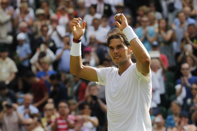 Rafael Nadal of Spain celebrates after defeating Martin Klizan of Slovakia in a match at the All England Lawn Tennis Championships in Wimbledon, London, Tuesday, June 24, 2014. (AP Photo/Sang Tan)