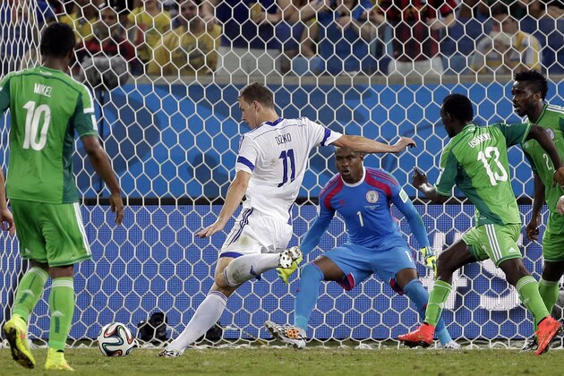 Bosnia's Edin Dzeko takes a shot on Nigeria's goalkeeper Vincent Enyeama in the closing seconds of the group F World Cup soccer match between Nigeria and Bosnia at the Arena Pantanal in Cuiaba, Brazil, Saturday, June 21, 2014. (AP Photo/Felipe Dana)