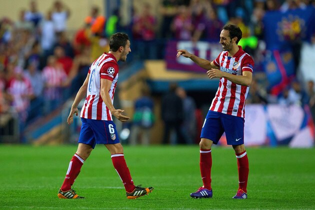 MADRID, SPAIN - APRIL 09:  Koke of Club Atletico de Madrid and Juanfran of Club Atletico de Madrid celebrate victory during the UEFA Champions League Quarter Final second leg match between Club Atletico de Madrid and FC Barcelona at Vicente Calderon Stadium on April 9, 2014 in Madrid, Spain.  (Photo by Gonzalo Arroyo Moreno/Getty Images)