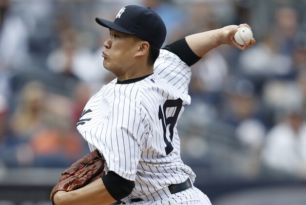 New York Yankees starting pitcher Masahiro Tanaka (19) delivers in the first inning of a baseball game against the Baltimore Orioles at Yankee Stadium in New York, Sunday, June 22, 2014.  (AP Photo/Kathy Willens)