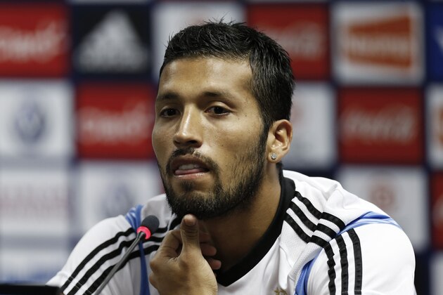 Argentina's Ezequiel Garay listens to questions during a news conference after a training session in Vespasiano, near Belo Horizonte, Brazil, Thursday, June 12, 2014. Argentina will play in group F of the Brazil 2014 soccer World Cup. (AP Photo/Victor R. Caivano)
