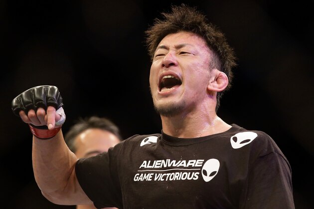 SINGAPORE - JANUARY 04:  Tatsuya Kawajiri reacts after defeating Sean Soriano during their UFC Fight Night Singapore featherweight bout at Marina Bay Sands on January 4, 2014 in Singapore.  (Photo by Suhaimi Abdullah/Getty Images)