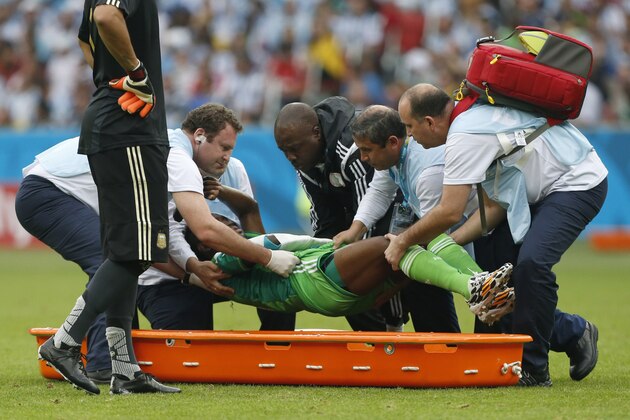 Nigeria's Michael Babatunde is lifted from the pitch before being taken off the field during the group F World Cup soccer match against Argentina at the Estadio Beira-Rio in Porto Alegre, Brazil, Wednesday, June 25, 2014. (AP Photo/Jon Super)