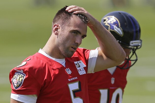 Baltimore Ravens quarterback Joe Flacco pauses during NFL football practice, Tuesday, June 17, 2014, at the team's practice facility in Owings Mills, Md. (AP Photo/Patrick Semansky)
