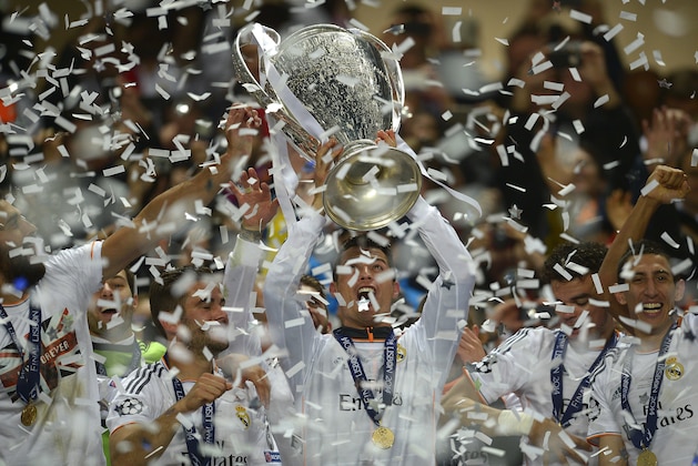 Real's Cristiano Ronaldo, centre, lifts the Champion League trophy, at the end of the Champions League final soccer match between Atletico Madrid and Real Madrid, at the Luz stadium, in Lisbon, Portugal, Saturday, May 24, 2014. (AP Photo/Manu Fernandez)