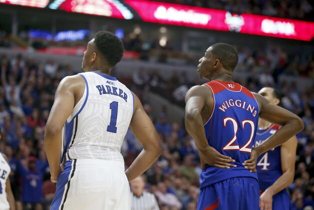 Duke forward Jabari Parker (1) and Kansas guard Andrew Wiggins (22) wait for a free throw during the second half of an NCAA college basketball game Tuesday, Nov. 12, 2013, in Chicago. Kansas won 94-83. (AP Photo/Charles Rex Arbogast)