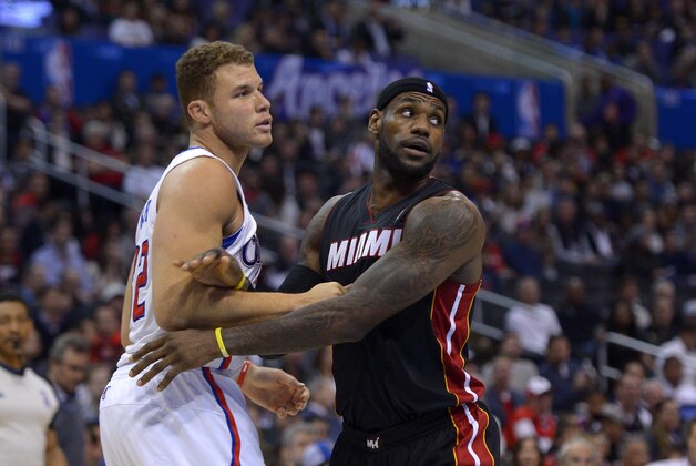 Los Angeles Clippers forward Blake Griffin, left, and Miami Heat forward LeBron James vie for a rebound during the first half of an NBA basketball game, Wednesday, Feb. 5, 2014, in Los Angeles. (AP Photo/Mark J. Terrill)