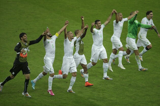 Members of the Algerian soccer team join hands as they celebrate on the pitch after winning 4-2 , the group H World Cup soccer match between South Korea and Algeria at the Estadio Beira-Rio in Porto Alegre, Brazil, Sunday, June 22, 2014. (AP Photo/Michael Sohn)