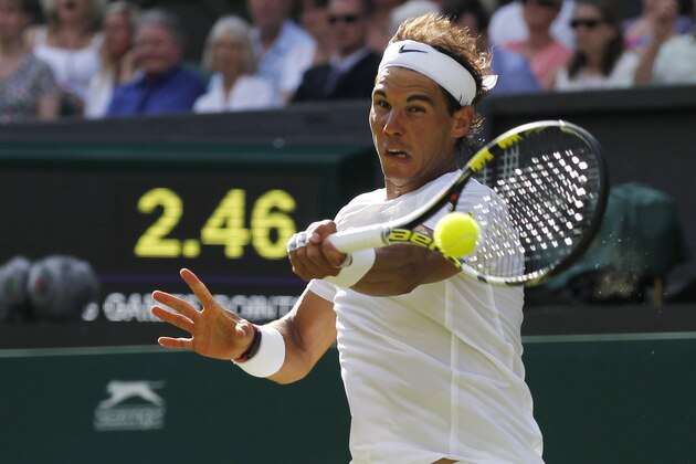 Rafael Nadal of Spain plays a return to Martin Klizan of Slovakia during their match at the All England Lawn Tennis Championships in Wimbledon, London, Tuesday, June 24, 2014. (AP Photo/Sang Tan)