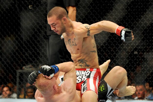 Jul 6, 2013; Las Vegas, NV, USA;  Cub Swanson (red gloves) and Dennis Siver (blue gloves) during their Featherweight Bout at the MGM Grand Garden Arena. Swanson won. Mandatory Credit: Jayne Kamin-Oncea-USA TODAY Sports