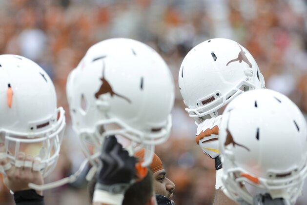 Apr 19, 2014; Austin, TX, USA; The Texas Longhorns raise their helmets prior to the Spring Game at Texas Memorial Stadium. Mandatory Credit: Brendan Maloney-USA TODAY Sports