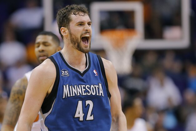 Minnesota Timberwolves forward Kevin Love (42) yells after hitting a three pointer against the Phoenix Suns during the second half of an NBA basketball game, Tuesday, Feb. 25, 2014, in Phoenix. (AP Photo/Matt York)