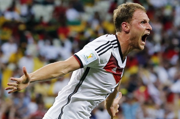 Germany's Benedikt Hoewedes celebrates after his teammate Miroslav Klose scored a goal during the group G World Cup soccer match between Germany and Ghana at the Arena Castelao in Fortaleza, Brazil, Saturday, June 21, 2014.  (AP Photo/Matthias Schrader)