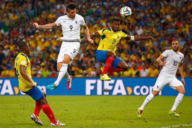 RIO DE JANEIRO, BRAZIL - JUNE 25: Olivier Giroud of France heads the ball toward goal against Gabriel Achilier of Ecuador during the 2014 FIFA World Cup Brazil Group E match between Ecuador and France at Maracana on June 25, 2014 in Rio de Janeiro, Brazil.  (Photo by Clive Rose/Getty Images)