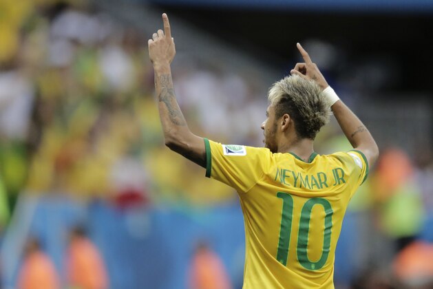 Brazil's Neymar celebrates after scoring his side's second goal during the group A World Cup soccer match between Cameroon and Brazil at the Estadio Nacional in Brasilia, Brazil, Monday, June 23, 2014. (AP Photo/Bernat Armangue)