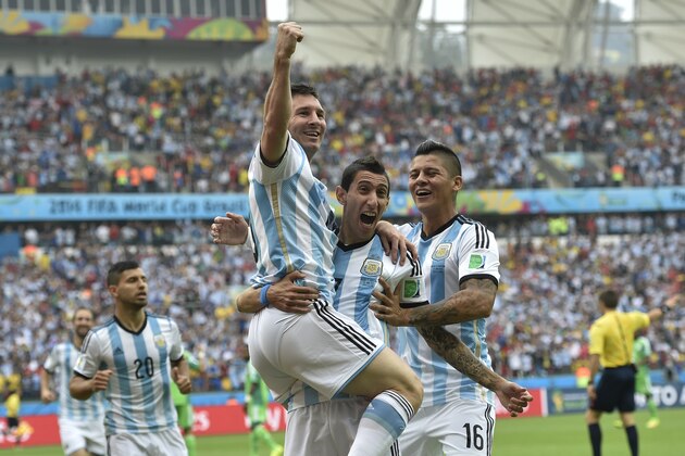 Argentina's Lionel Messi, left, is carried by his teammates Argentina's Angel di Maria (7) and Argentina's Marcos Rojo after scoring his side's first goal during the group F World Cup soccer match between Nigeria and Argentina at the Estadio Beira-Rio in Porto Alegre, Brazil, Wednesday, June 25, 2014. (AP Photo/Martin Meissner)