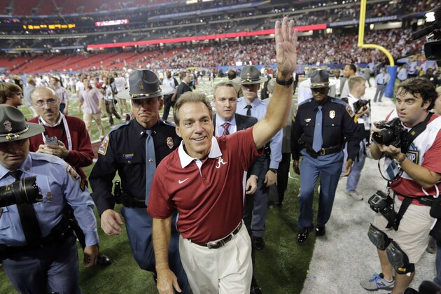 ADVANCE FOR WEEKEND EDITIONS, AUG. 10-11 - FILE - In this Dec. 1, 2012, file photo, Alabama head coach Nick Saban waves as he leaves the field after their 32-28 win over Georgian in the  Southeastern Conference championship NCAA college football game in Atlanta. Saban is rapidly gaining on Paul